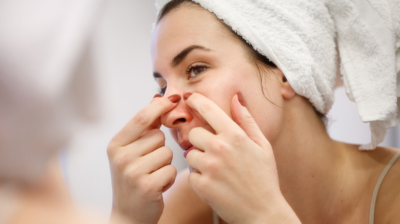 woman popping pimple