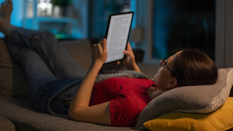 Woman reading book on Kindle