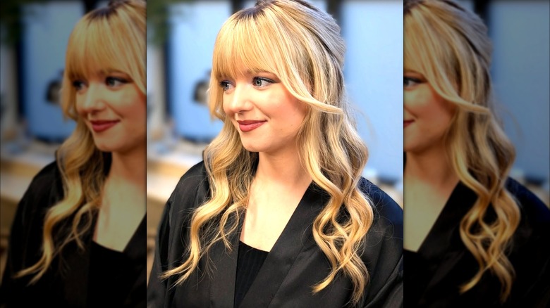 A woman with a half-up, half-down wedding hairstyle.