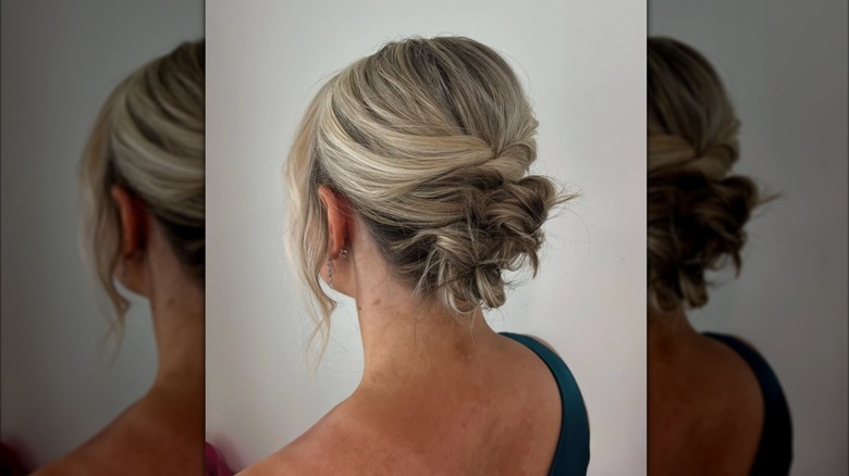 A woman shows her low bun.