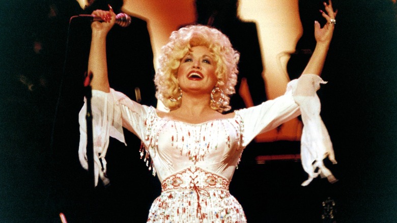 Dolly Parton performs onstage in the 1980s.