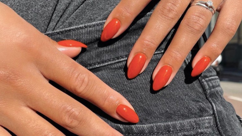 Almond-shaped manicure with burnt orange nail polish
