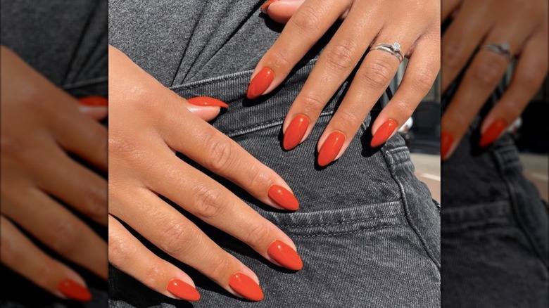 Almond-shaped manicure with burnt orange nail polish