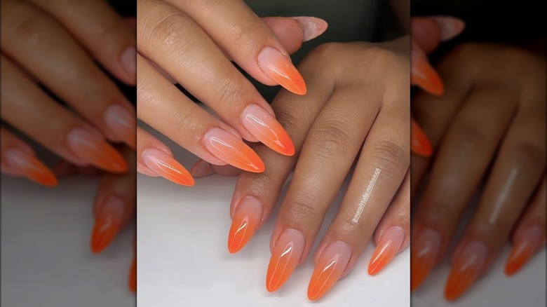 Long rounded manicure with orange ombre French tips
