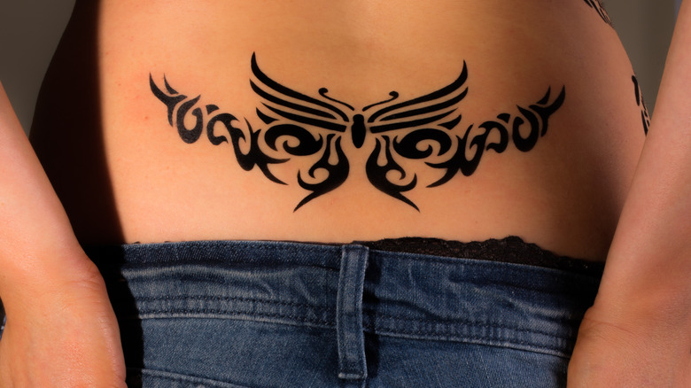 Woman tattoo lower back