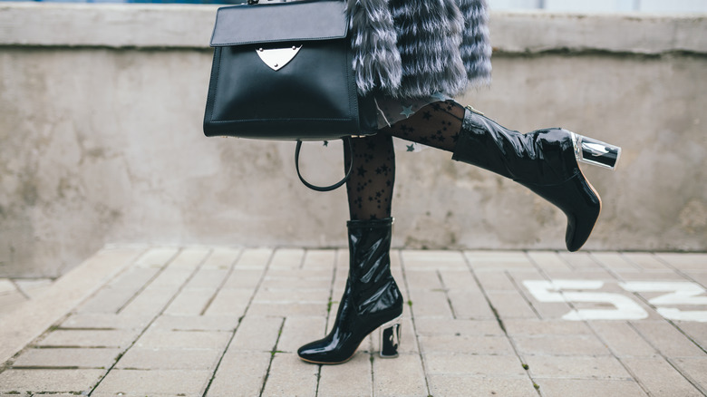 woman wearing vinyl ankle boots