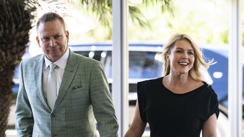 Karoline Leavitt and her husband walking into a Palm Beach wedding