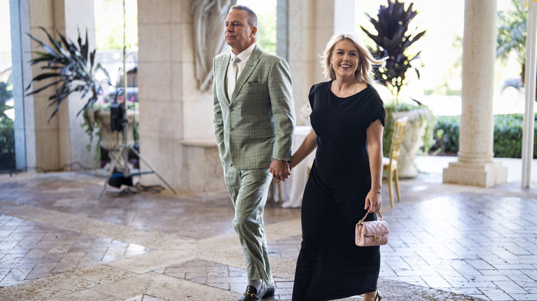 Nicholas Riccio holding Karoline Leavitt's hands as they walk into Mar-A-Lago