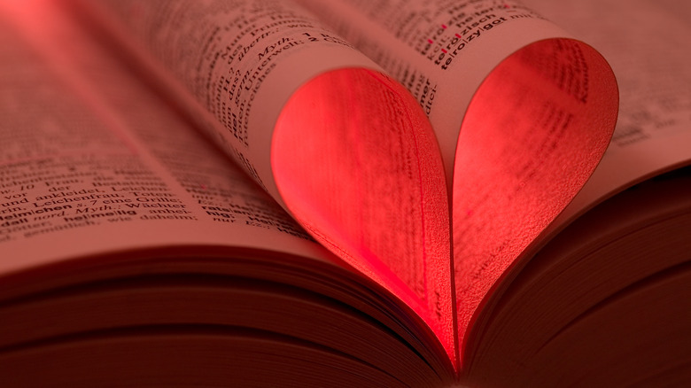 Book pages folded into red heart shape
