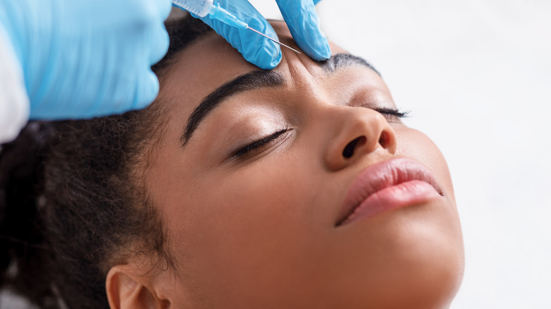 Woman receiving Botox treatment in glabella region