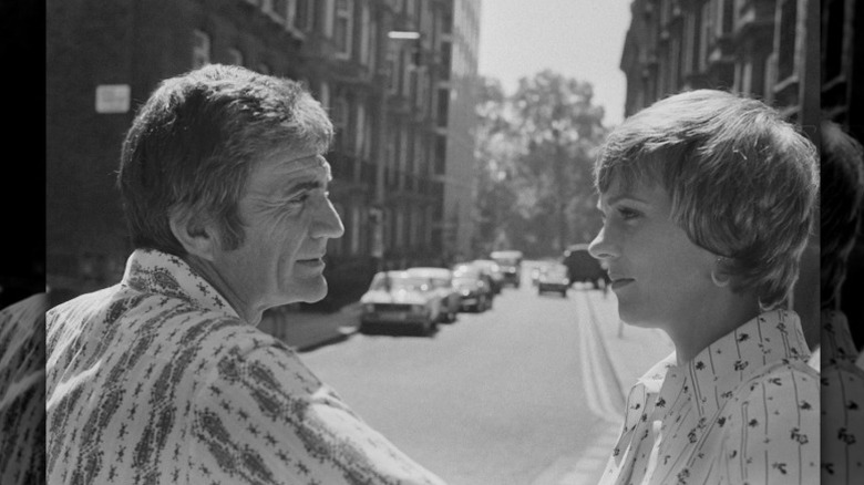 Blake Edwards looks at wife Julie Andrews on the street in London