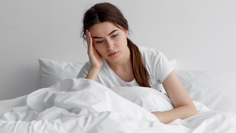 Woman distressed in bed