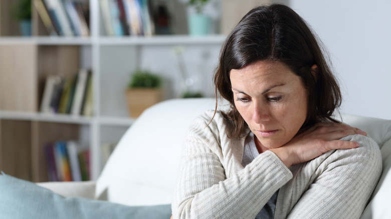 Woman who is sad sitting on the couch