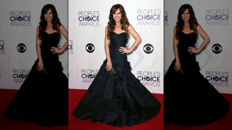 Nikki DeLoach wearing a black floor-length gown to the 2015 People's Choice Awards