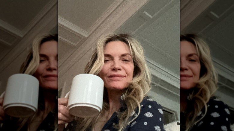 Michelle Pfeiffer holds a mug and wears no makeup