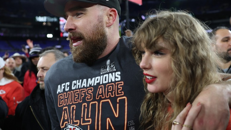 Travis Kelce with his arm around Taylor Swift after a football game