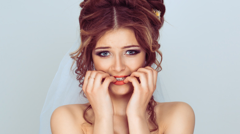 Anxious bride biting nails