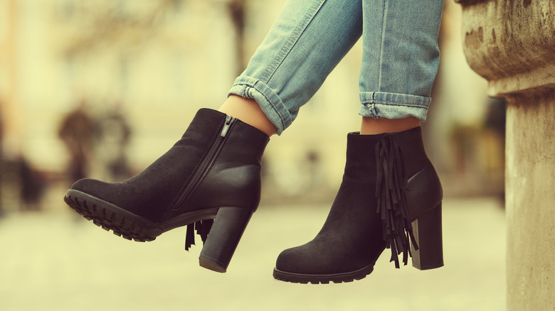 woman wearing black suede boots