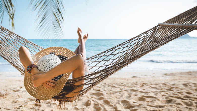 Woman in hammock on beach