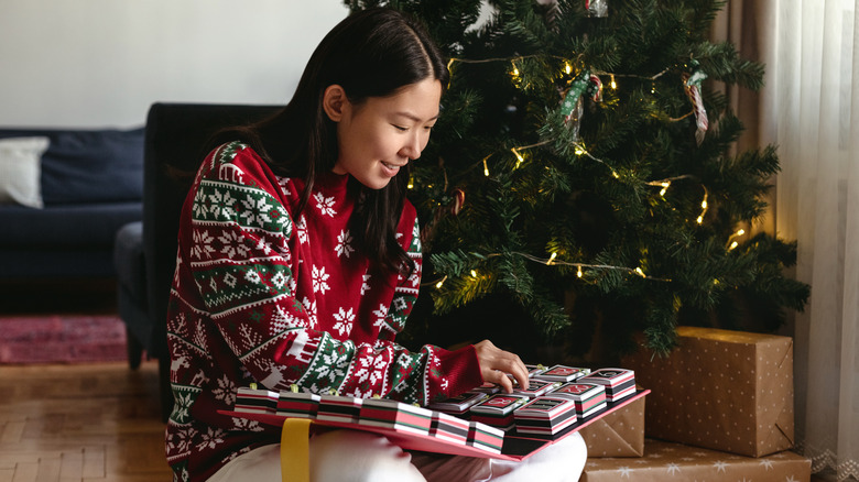 Woman opens Advent calendar 