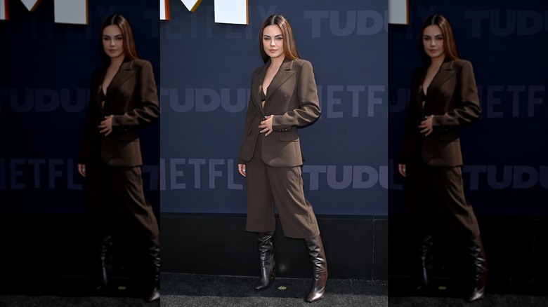 Mila Kunis poses on the "Tudum" red carpet.