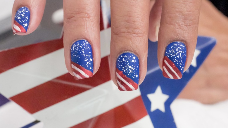 Red, white, and blue nails holding an American flag-print star.