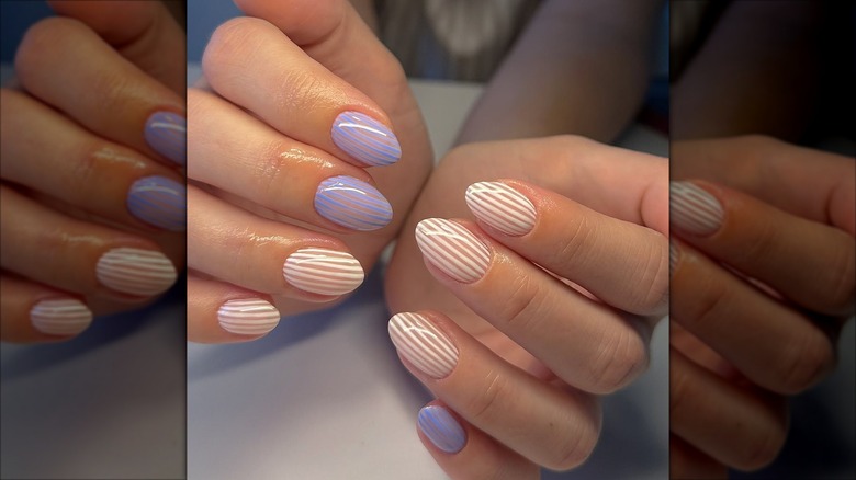 Short nails with blue and white thin pinstripes.