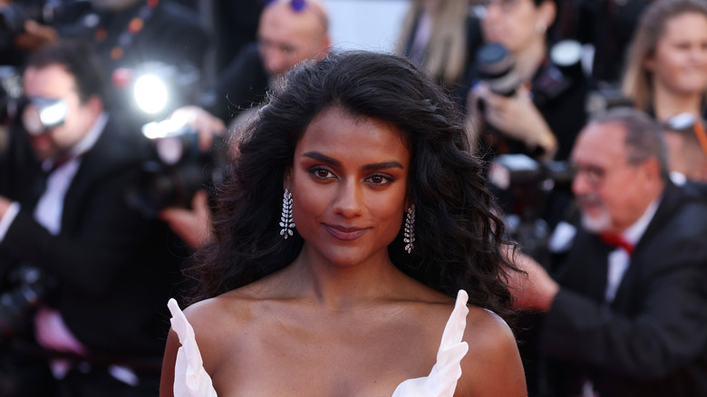Simone Ashley wearing a white dress