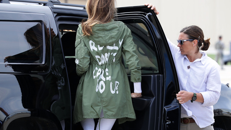 Melania Trump (C) climbs back into her motorcade after traveling to Texas to visit facilities that house and care for children taken from their parents at the U.S.-Mexico border June 21, 2018 at Joint Base Andrews, Maryland (2018)