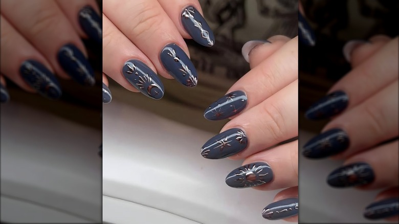 Round manicure with gray-blue nail polish and celestial designs