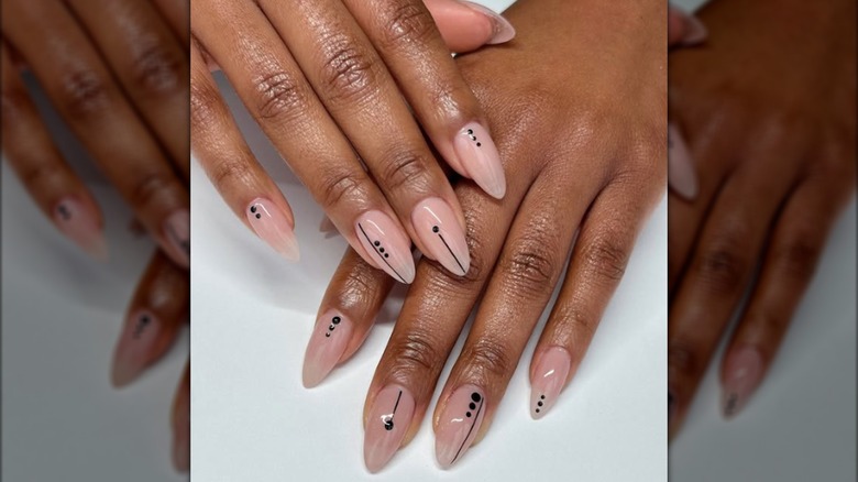 Almond-shaped minimalist manicure with black geometric designs