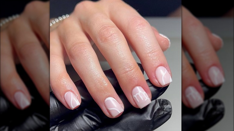 Short square manicure with white painted Virgo symbol