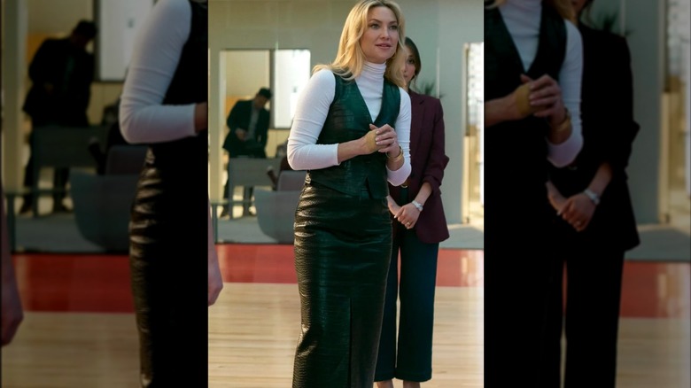 Kate Hudson in a leather vest and skirt set with a white turtleneck underneath