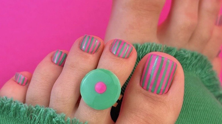 Turquoise and hot pink striped pedicure