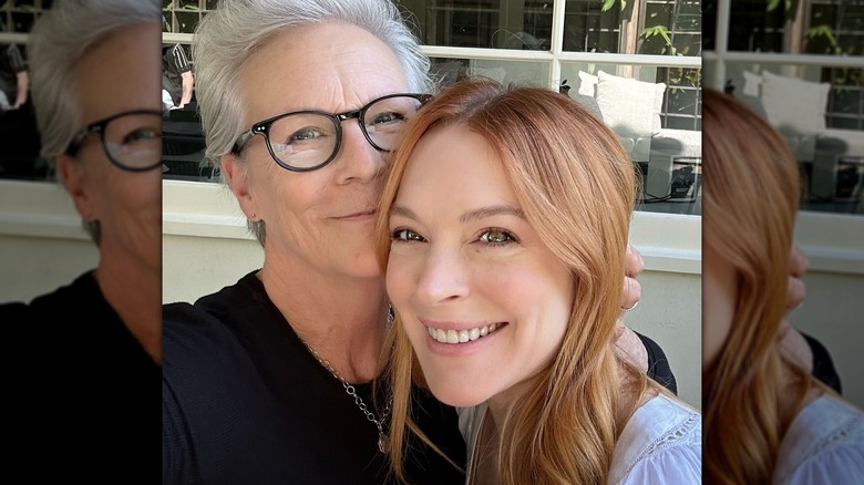 Jamie Lee Curtis and Lindsay Lohan smiling in a selfie together.