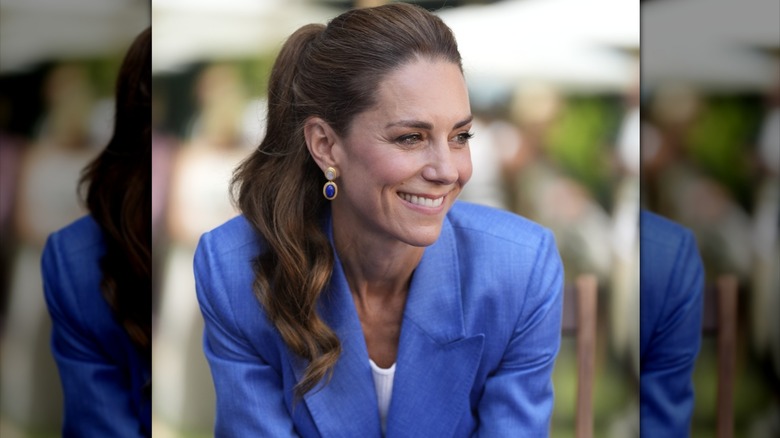 Kate Middleton wears a sky-blue jacket paired with a high ponytail while attending the 2026 Wimbledon Tennis Championship in London, England in July of 2026.