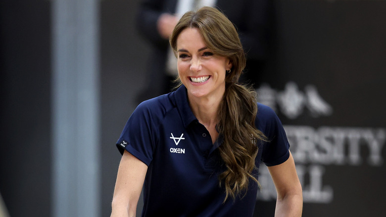 Kate Middleton wears a navy blue shirt with a side ponytail while playing wheelchair rugby during a Rugby Day Inclusivity Day in Hull, England in October 2023.