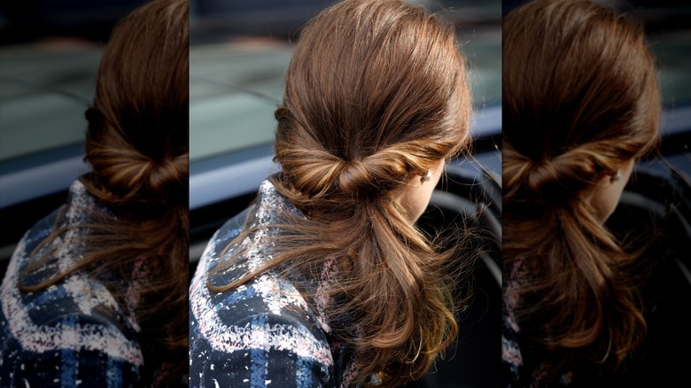 Kate Middleton wore a navy, blue, pink, and white plaid jacket with her hair in a low ponytail at a reception at the National Football Museum in October 2016.