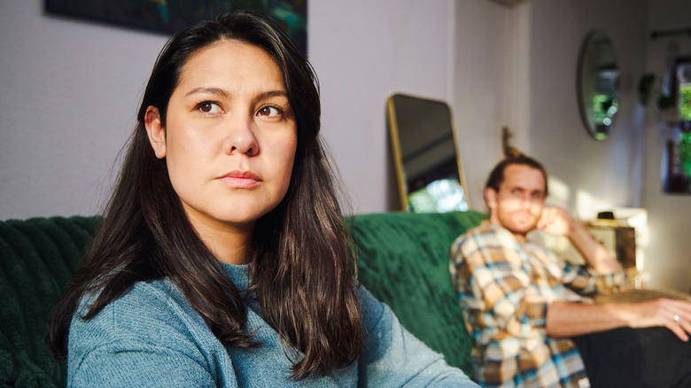 Unhappy couple on sofa