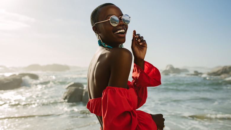 Woman outside at beach smiling