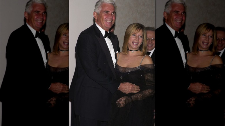 James Brolin in a tux posing with wife Barbra Streisand wearing a sparkly dress at an event.