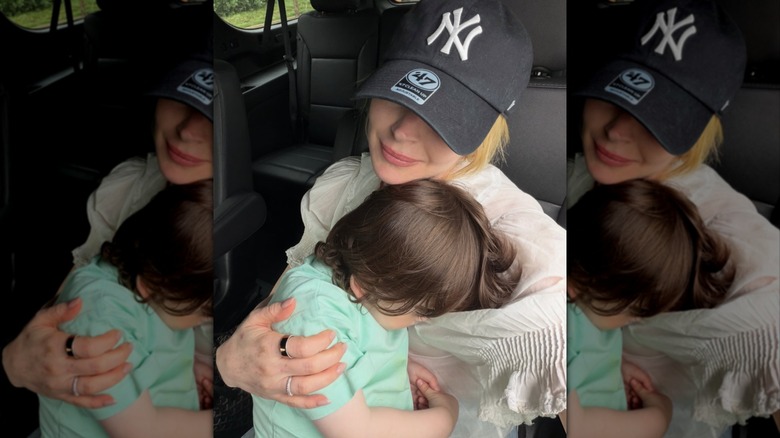 Lindsay Lohan holds son Luai in the car