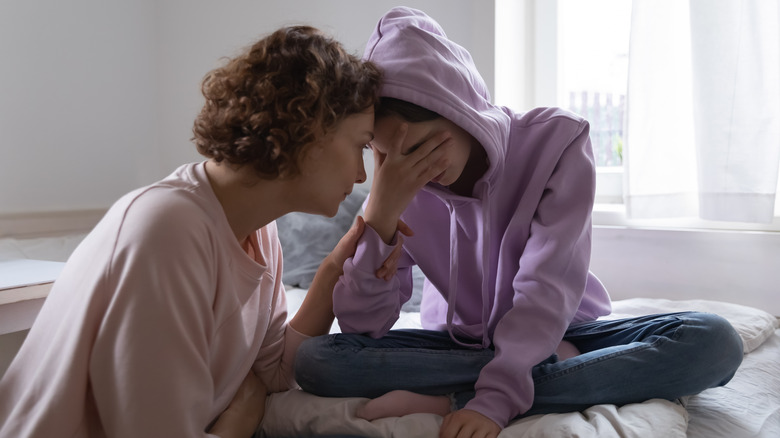 Older woman comforting younger woman