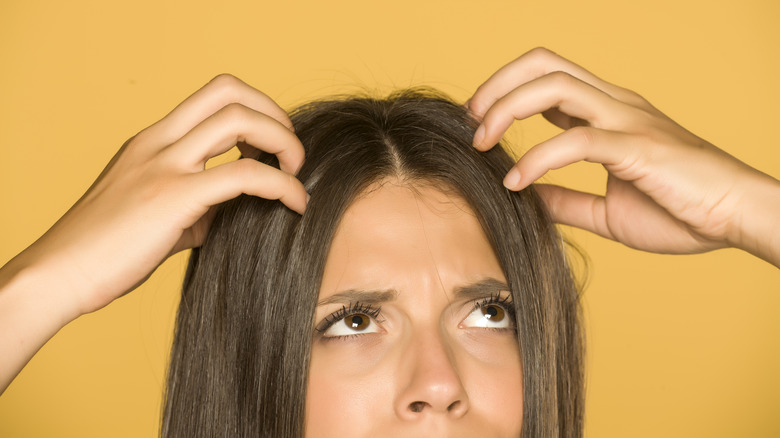 concerned woman scratching head