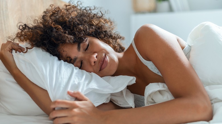 Woman with curly hair sleeping