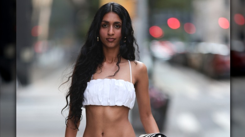A woman on the street wears her hair down to her belly button