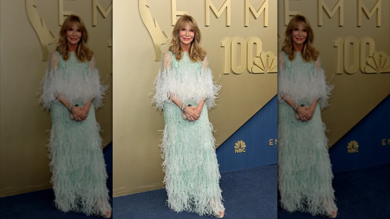 Jaclyn Smith wearing a sea-foam green feathered Monique Lhuillier dress on the red carpet at the 2026 Emmy Awards.