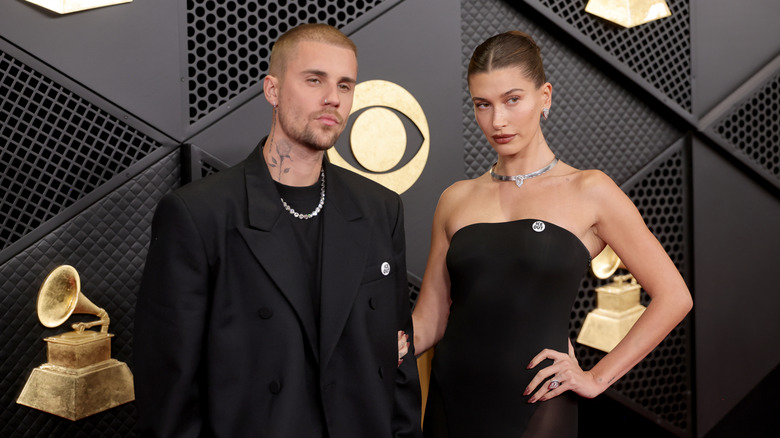 Justin Bieber and Hailey Bieber pose on the Grammys red carpet in black