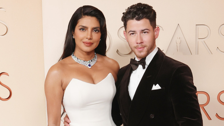 Priyanka Chopra Jonas and Nick Jonas smile together at the Oscars