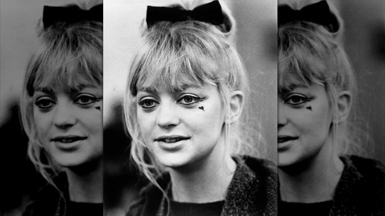 Goldie Hawn wears a unique eyeliner look and heart on her face